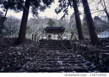 The shrine's approach and the snow-covered stone steps are enveloped in the winter silence. The shrine's approach and the snow-covered stone steps are enveloped in the winter silence. 139719400