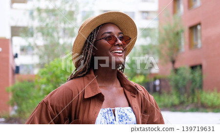 Young woman resting and relaxing while walking on city street in new eco-friendly residential complex. Relaxation and stress-free concept. Young woman resting and relaxing while walking on city street in new eco-friendly residential complex. Relaxation and stress-free concept. 139719631