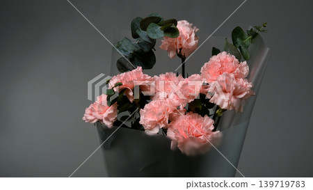 Bouquet of pink carnations on a gray background. Florist assembly a bouquet to order Bouquet of pink carnations on a gray background. Florist assembly a bouquet to order 139719783