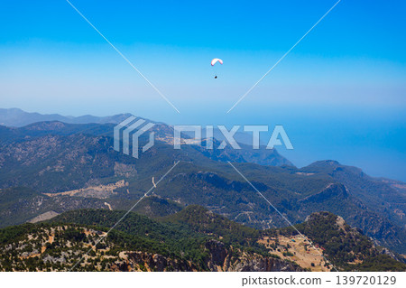 Flying paraglider at Babadag mountain in Turkey Flying paraglider at Babadag mountain in Turkey 139720129