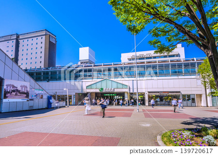 Yokohama, Japan, cityscape, May 17th. A view of Sakuragicho Station and trains, adorned with fresh greenery. The rooftop of Pio City features a white sign... Yokohama, Japan, cityscape, May 17th. A view of Sakuragicho Station and trains, adorned with fresh greenery. The rooftop of Pio City features a white sign... 139720617