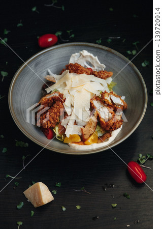 Crispy chicken salad topped with cheese and fresh vegetables Crispy chicken salad topped with cheese and fresh vegetables 139720914