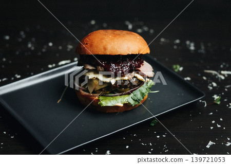 Gourmet burger with fresh ingredients on dark plate Gourmet burger with fresh ingredients on dark plate 139721053