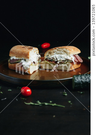 Deliciously filled sandwich with creamy cheese, served on rustic plate Deliciously filled sandwich with creamy cheese, served on rustic plate 139721065