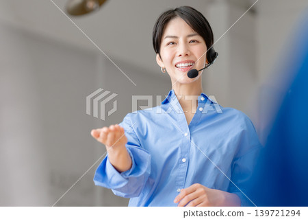 Businesswoman speaking with an intercom Businesswoman speaking with an intercom 139721294