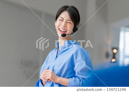 Businesswoman speaking with an intercom Businesswoman speaking with an intercom 139721299