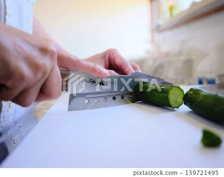 Shred the cucumber with a Santoku knife 139721495