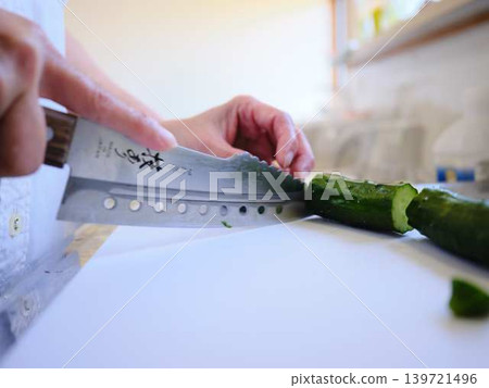 Shred the cucumber with a Santoku knife Shred the cucumber with a Santoku knife 139721496