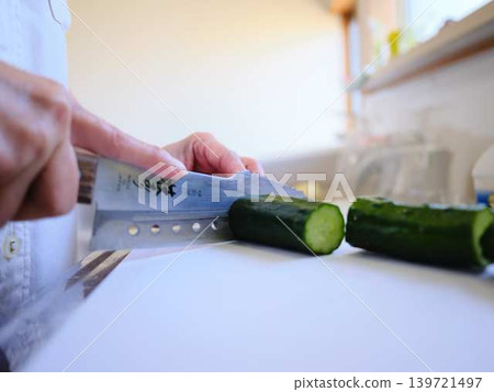 Shred the cucumber with a Santoku knife Shred the cucumber with a Santoku knife 139721497