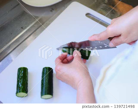 Shred the cucumber with a Santoku knife Shred the cucumber with a Santoku knife 139721498