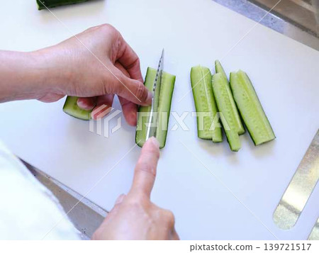 Shred the cucumber with a Santoku knife Shred the cucumber with a Santoku knife 139721517