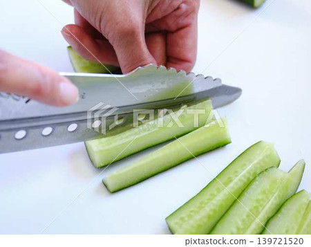 Shred the cucumber with a Santoku knife 139721520