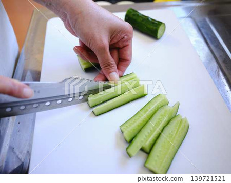 Shred the cucumber with a Santoku knife 139721521