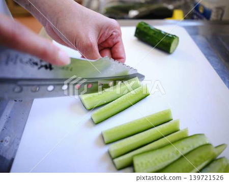Shred the cucumber with a Santoku knife 139721526