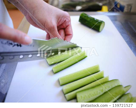 Shred the cucumber with a Santoku knife Shred the cucumber with a Santoku knife 139721527