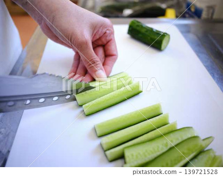 Shred the cucumber with a Santoku knife Shred the cucumber with a Santoku knife 139721528
