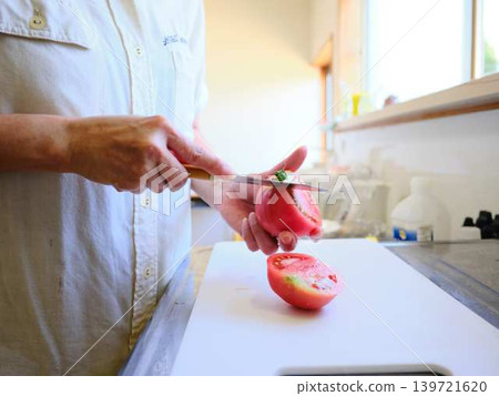 A young woman cooking tomatoes A young woman cooking tomatoes 139721620