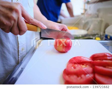A young woman cooking tomatoes A young woman cooking tomatoes 139721682