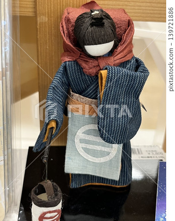 A Japanese doll of a girl carrying a large bag A Japanese doll of a girl carrying a large bag 139721886