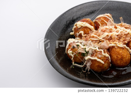 Takoyaki on a black plate with ample space. Takoyaki on a black plate with ample space. 139722232