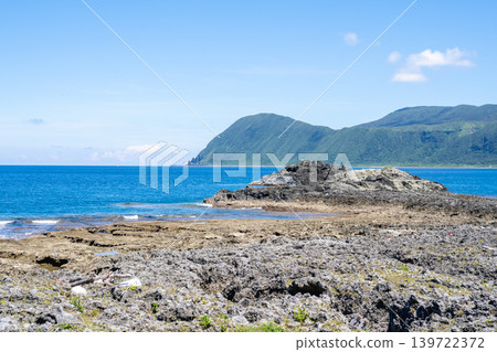 Lanyu, Taiwan: Panoramic view of the volcanic rock coastline, overlooking the mountains and the Pacific Ocean. Lanyu, Taiwan: Panoramic view of the volcanic rock coastline, overlooking the mountains and the Pacific Ocean. 139722372