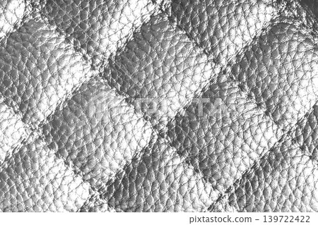 Macro of white quilted leather texture background with stitched pattern and shining metal effect 139722422