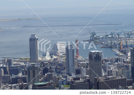 A view of the bay area cityscape, with towers and buildings lining the harbor. A view of the bay area cityscape, with towers and buildings lining the harbor. 139722724