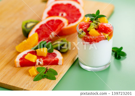 vibrant healthy snack with yogurt fruit mix and mint leaves composition vibrant healthy snack with yogurt fruit mix and mint leaves composition 139723201