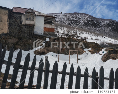 Snow-dusted village nestled in mountain valley. Svaneti. Georgia Snow-dusted village nestled in mountain valley. Svaneti. Georgia 139723471