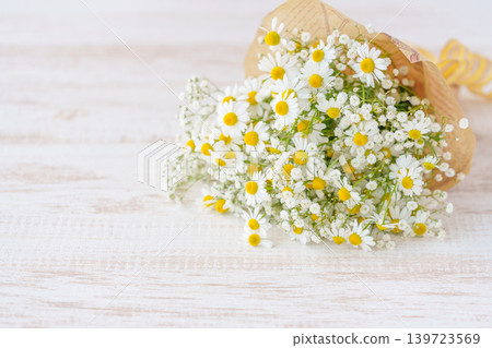 A bouquet of chamomile and baby's breath. A bouquet of chamomile and baby's breath. 139723569