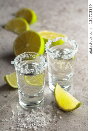 Tequila with salt and lime slices. Tequila with salt and lime slices. 139723589