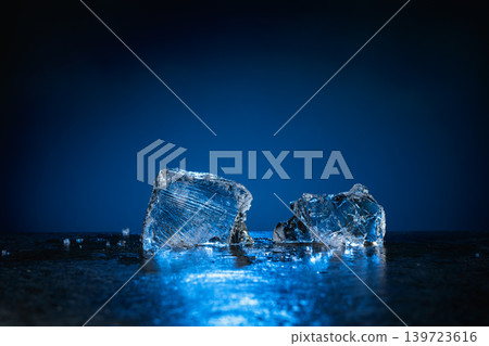 Broken ice with blue backlight on a dark background. Broken ice with blue backlight on a dark background. 139723616
