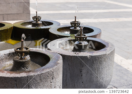 Drinking fountains with weathered stone basins placed at Republic Square of Yerevan Drinking fountains with weathered stone basins placed at Republic Square of Yerevan 139723642