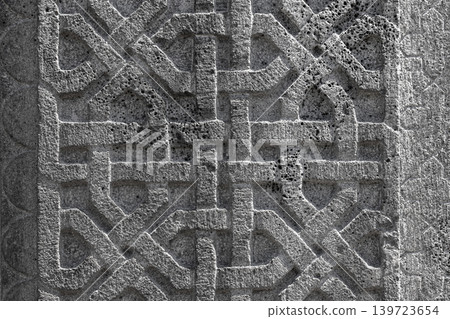 Intricate stone carving showing knotwork and geometric pattern, background texture Intricate stone carving showing knotwork and geometric pattern, background texture 139723654