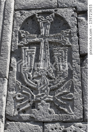 An ornate stone cross carved in relief on an ancient church wall. Highpat monastery An ornate stone cross carved in relief on an ancient church wall. Highpat monastery 139723655