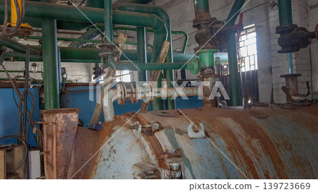 Industrial Boiler Room Interior with Rusty Tank and Green Pipes Industrial Boiler Room Interior with Rusty Tank and Green Pipes 139723669