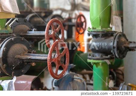 Industrial Red Valve Wheels in Heavy Duty Pipe System Industrial Red Valve Wheels in Heavy Duty Pipe System 139723671
