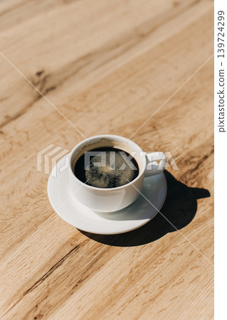 Cup of black coffee on a wooden table in a street cafe. Place for text. Cup of black coffee on a wooden table in a street cafe. Place for text. 139724299
