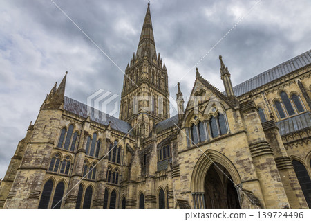 Historic Salisbury Cathedral exterior with its famous tall spire Historic Salisbury Cathedral exterior with its famous tall spire 139724496
