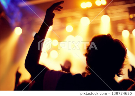 Night, club and man dance at concert, event or music festival with stage lights and silhouette. Dark, nightclub and person in audience, crowd and social celebration at techno rave with energy Night, club and man dance at concert, event or music festival with stage lights and silhouette. Dark, nightclub and person in audience, crowd and social celebration at techno rave with energy 139724650