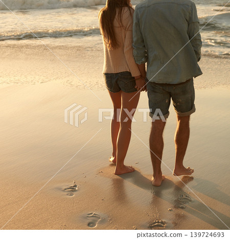 Beach, sunset and couple holding hands with love, support and relationship security on summer holiday in Portugal. Mockup space, sand and back of partner, soulmate or people on evening walk together Beach, sunset and couple holding hands with love, support and relationship security on summer holiday in Portugal. Mockup space, sand and back of partner, soulmate or people on evening walk together 139724693