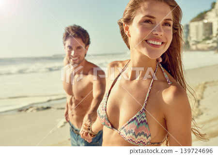 Travel, smile and couple holding hands while walking at a beach with love, adventure or bonding in nature. Happy, care or people at sea for summer, date or romantic journey with support, fun or trust Travel, smile and couple holding hands while walking at a beach with love, adventure or bonding in nature. Happy, care or people at sea for summer, date or romantic journey with support, fun or trust 139724696