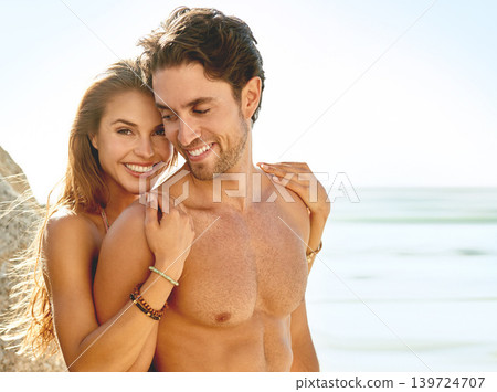 Happy couple, portrait and hug on beach for love, care or support on holiday or outdoor weekend. Face of young man and woman smile for embrace, trust or summer sunshine by ocean coast on mockup space 139724707