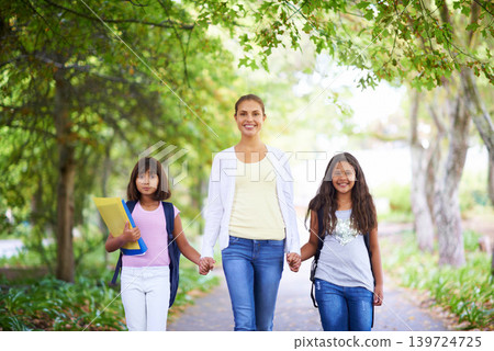 Mother, daughter and holding hands outdoor for school with portrait, happiness and backpack or books. Family, woman and children in park with support for education, learning and parenting with love Mother, daughter and holding hands outdoor for school with portrait, happiness and backpack or books. Family, woman and children in park with support for education, learning and parenting with love 139724725