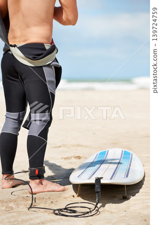 Beach, legs and surfboard rope in summer for exercise, fitness and workout outdoor. Surfer, wetsuit and person with leash by ocean for safety preparation, water sports and travel on holiday by sea 139724759