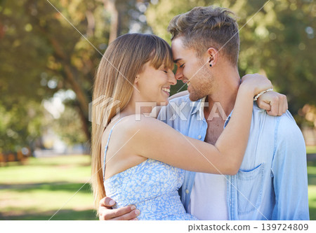 Couple, nose touch and hug in park with happiness outdoor, love and commitment for healthy relationship. Romantic date in nature, loyalty or respect with people and smile together in public garden 139724809