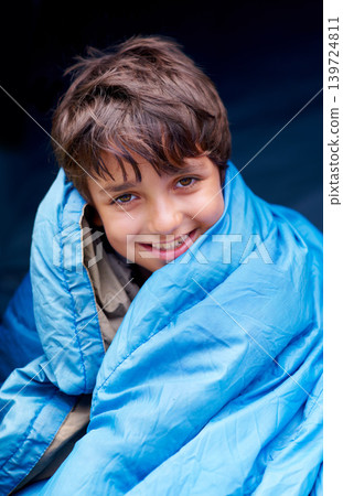 Travel, camping and portrait of child in sleeping bag for resting, relax and comfortable in tent gear. Happy, youth and boy in sleep sack for adventure on holiday, vacation and weekend outdoors 139724811