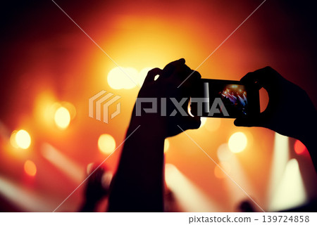 Hands, smartphone or image of band at concert, music event or audience with light in bokeh. Person, photography or picture on cellphone, technology or celebration with crowd at disco performance Hands, smartphone or image of band at concert, music event or audience with light in bokeh. Person, photography or picture on cellphone, technology or celebration with crowd at disco performance 139724858