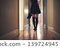 Woman, legs and walking with shoes in hallway for fashion, clothing or outing at home. Closeup of young female person in dress and leggings by door for sneaking, silence or quiet foot steps at house 139724945