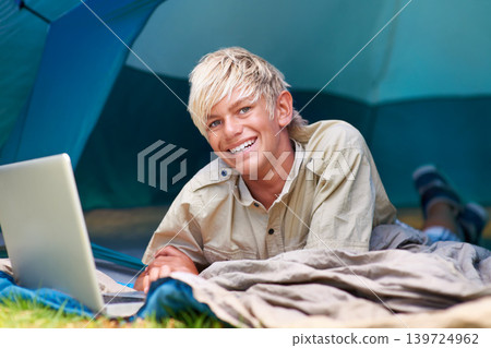 Child, boy and happy with laptop in tent for camping, social media and online movie with portrait in nature. Person, face and kid with smile outdoor on grass for gaming, vacation and holiday fun Child, boy and happy with laptop in tent for camping, social media and online movie with portrait in nature. Person, face and kid with smile outdoor on grass for gaming, vacation and holiday fun 139724962